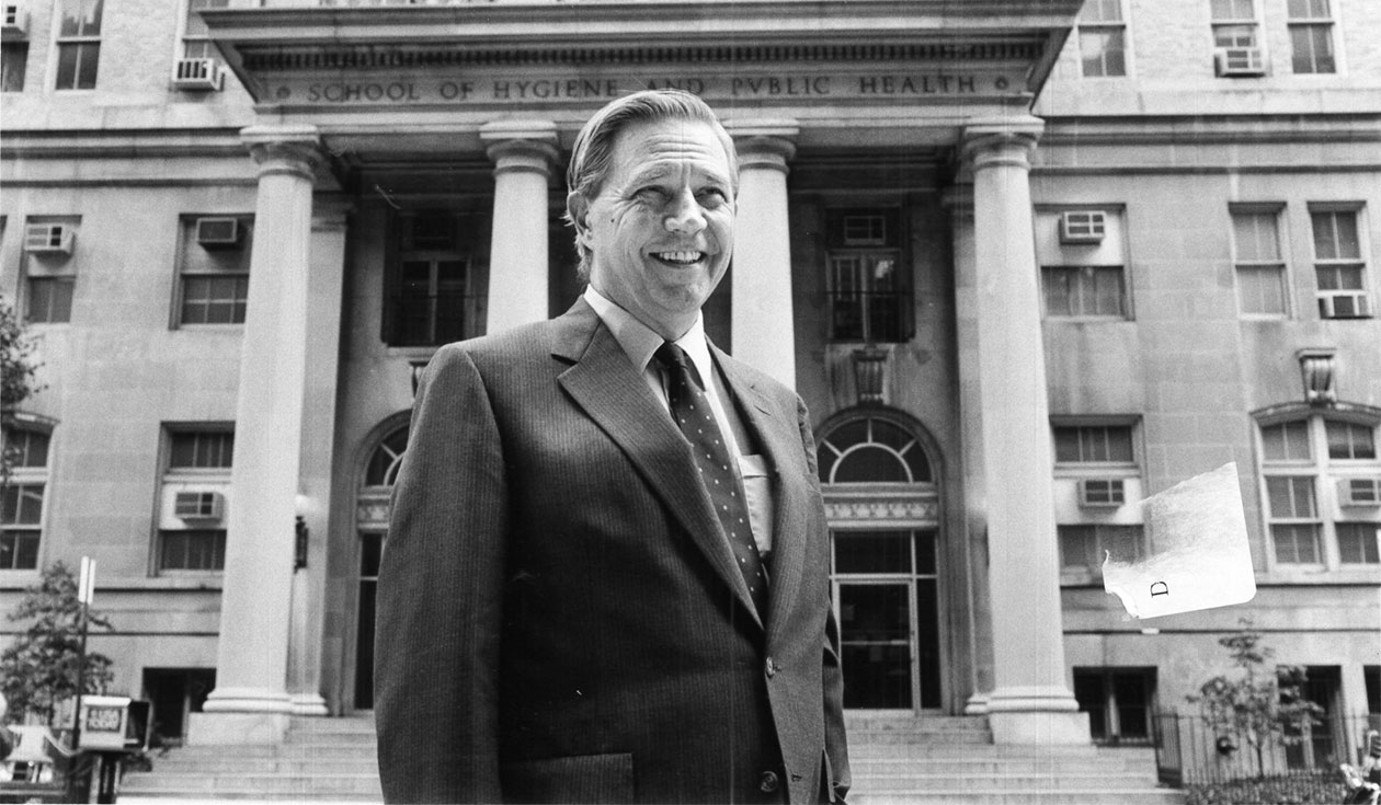 D.A.Henderson in front of Bloomberg School building