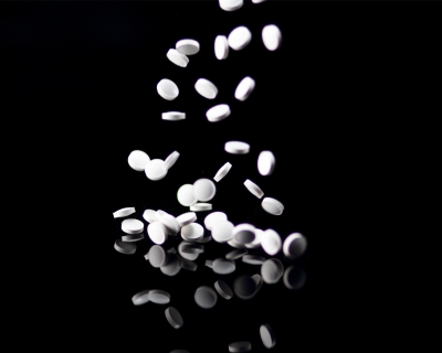 Ketamine pills fall onto a table. 