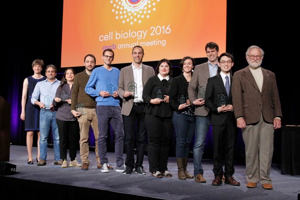 Anthony Leung and 10 other people lined up on a stage in front of a screen reading cell biology 2016 ascb annual meeting