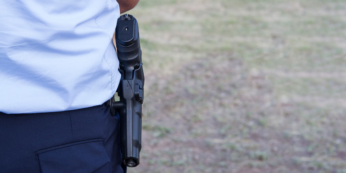 Thematic photograph of handgun in holster.