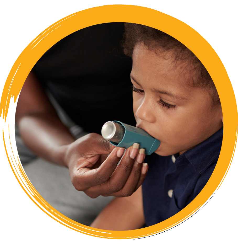 african-american child using asthma inhaler