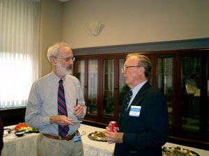 Richey Sharrett (left), adjunct professor of Epidemiology, talks with Thomas M. Daniel.