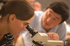 faculty with microscope