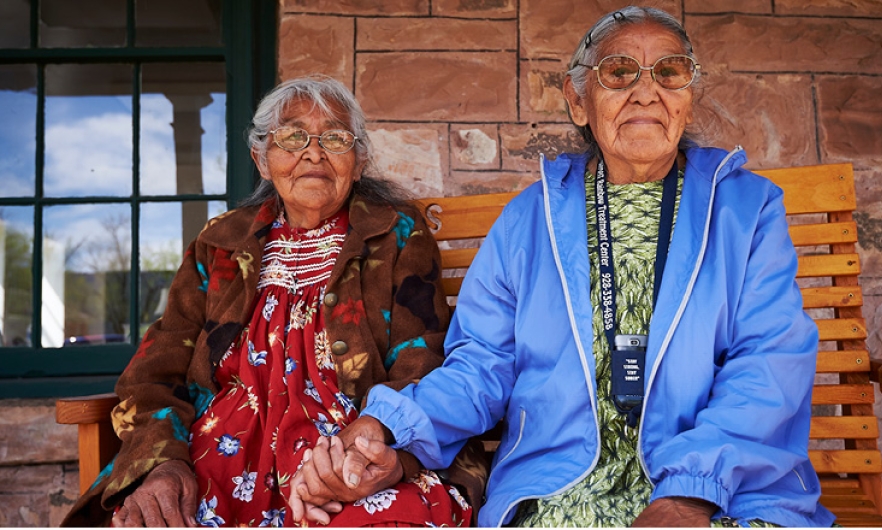American Indian Women sitting on a bench