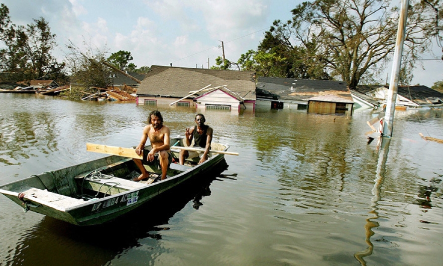 Man in a boat after Hurricane Katrina