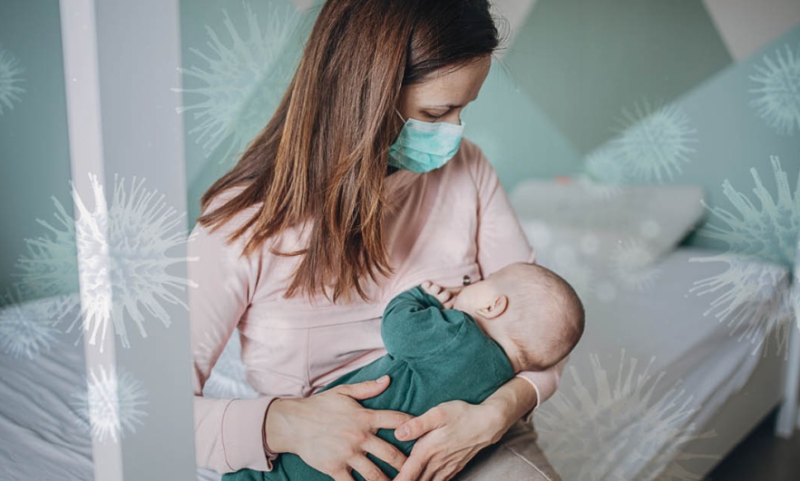 woman breastfeeding baby with mask on