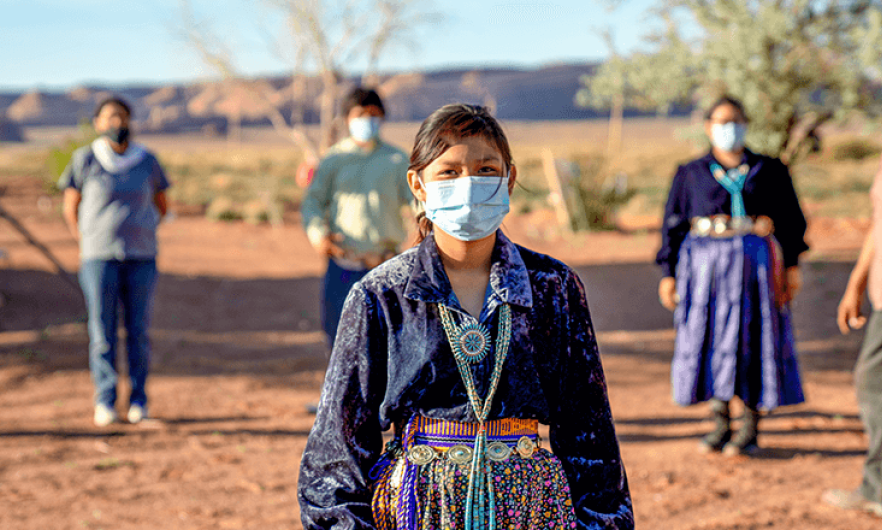 Native American woman wearing a mask