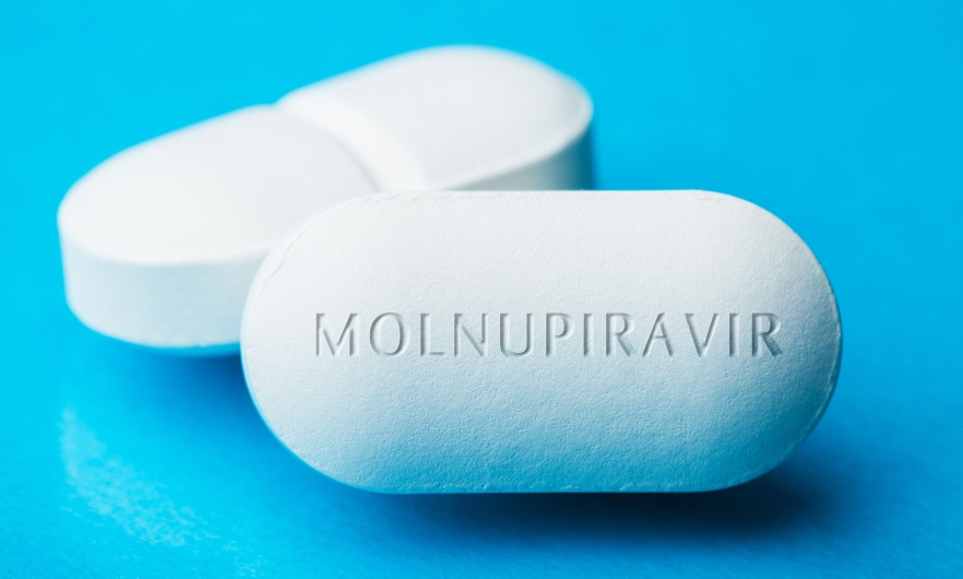 white pills with the word "molnupiravir" written
