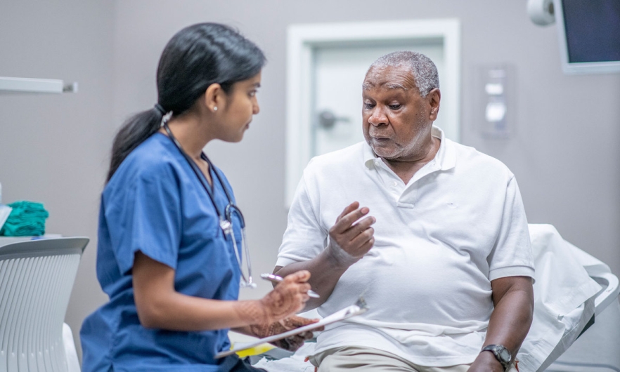 Elderly man consulting with a doctor 