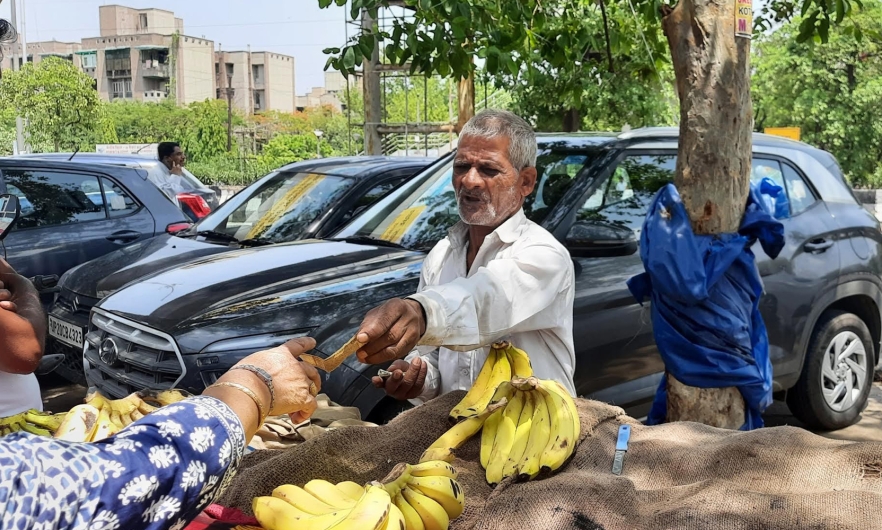 Extreme heat means few customers and little rest for Habib Khan, 65, a banana vendor outside Delhi. Swagata Yadavar.