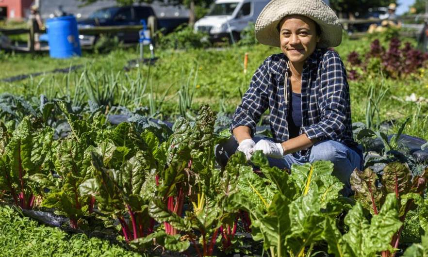 Young woman smiling in a community garden