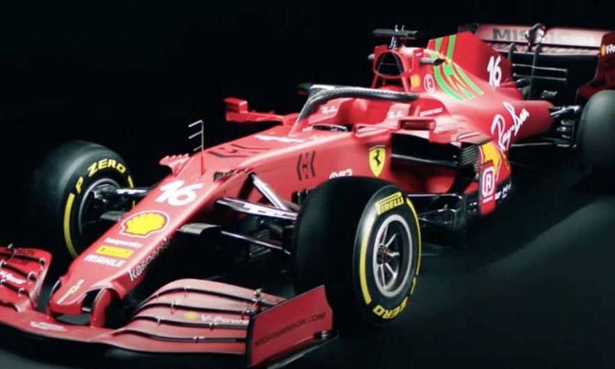 Red formula one race car bearing the logos of multiple corporate sponsors