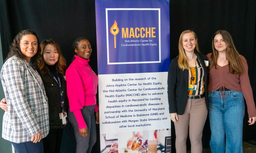 MACCHE Team Members Stand with MACCHE Sign