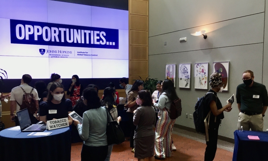 A group of BSPH students, staff, and faculty members discuss work opportunities during IGTC's 2022 student meet-and-greet event hosted at the Wall of Wonder