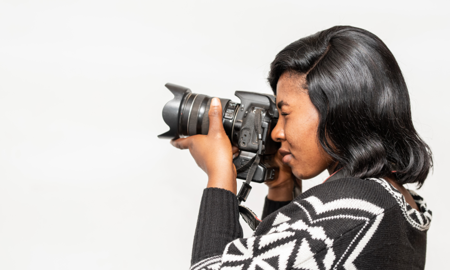 Black woman taking photos with a camera