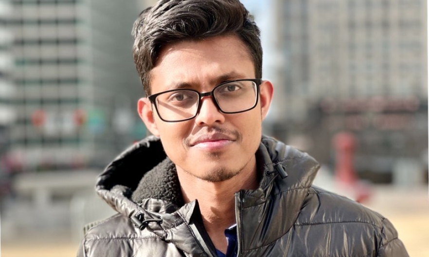 Young man wearing glasses standing in urban setting