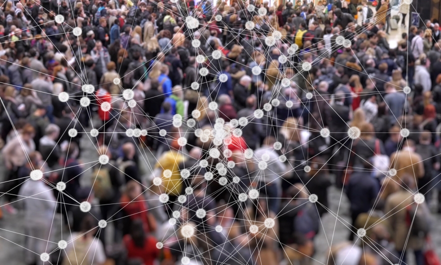 Conceptual image of disease particles connecting over a large crowd of people.