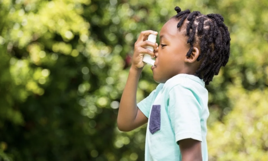 child using an asthma inhaler