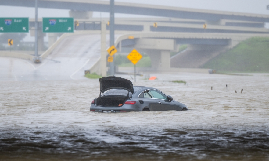 A vehicle is left abandoned in floodwater on a highway after Hurricane Beryl swept through the area on July 8, 2024, in Houston, Texas.