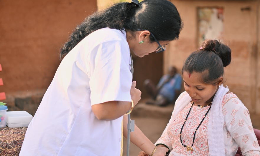 Community health worker conducting a routine examination and providing prenatal care in rural India