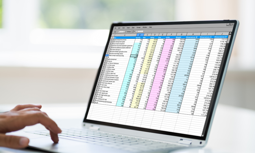 Person working in a spreadsheet on a laptop