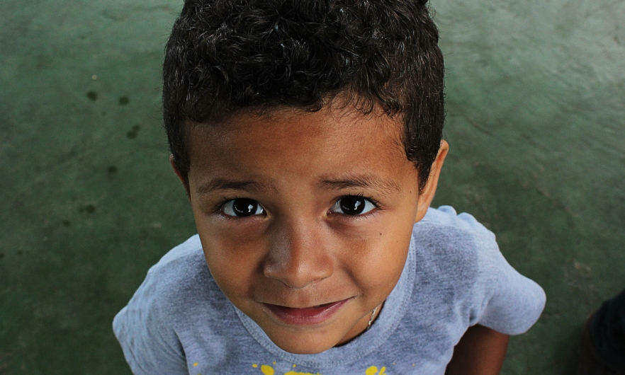 A picture of a Jose, a Brazilian kid, looking up at the camera