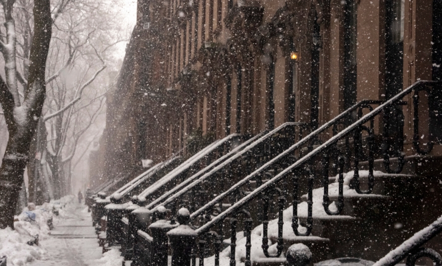 Brownstone rowhomes in light snowfall