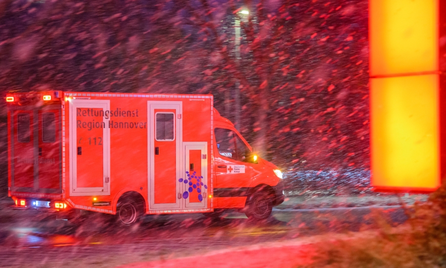 An ambulance drives through Laatzen, Germany in heavy snow during a surge in COVID-19 cases on January 31, 2022.