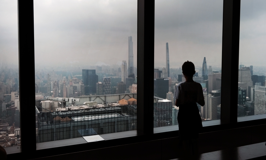 A child looks out at a hazy skyline from an overlook in midtown Manhattan on July 19, 2023 in New York City.