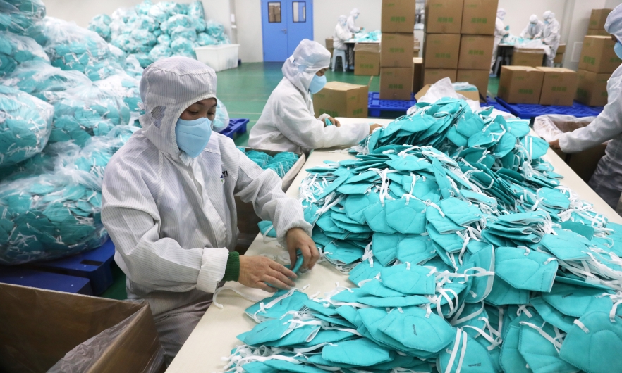 Employees work on the production line of N95 facemasks at a factory on December 8, 2022 in Xuchang, Henan Province of China. Niu Shupei/VCG via Getty Images