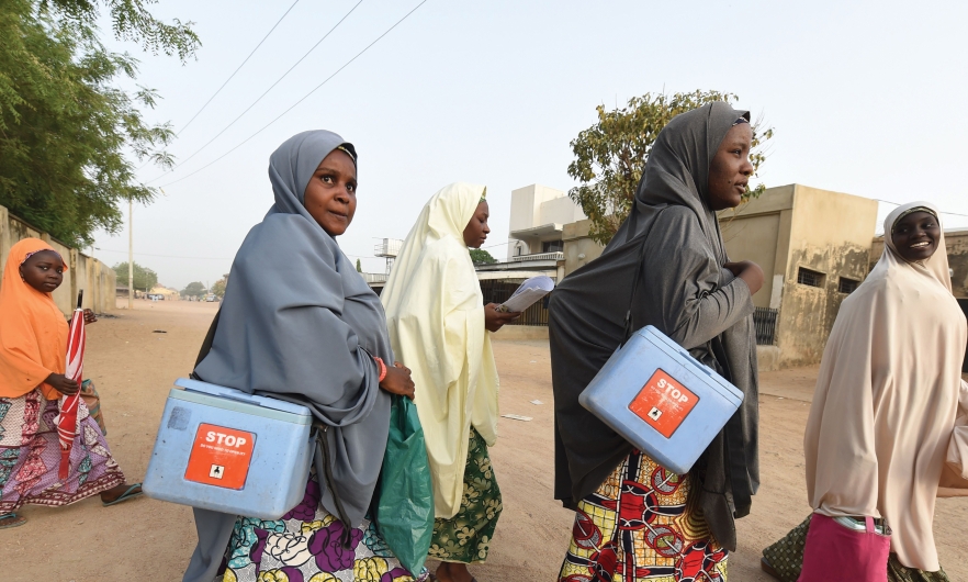 Health workers walk from house to house during a polio vaccination campaign in Hotoro-Kudu, Nassarawa district of Kano, Nigeria. April 22, 2017.  Pius Utomi Ekpei/AFP via Getty Images