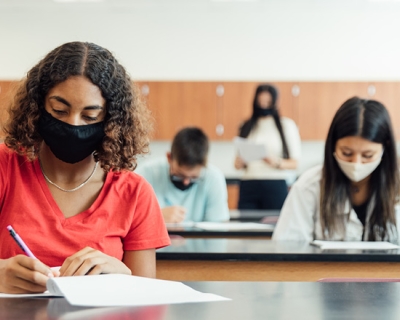 College students in masks studying