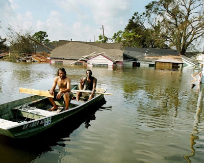 Man in a boat after Hurricane Katrina
