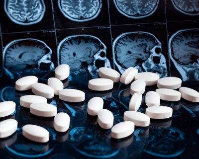 A composite image of pills overlaid on MRI imagery