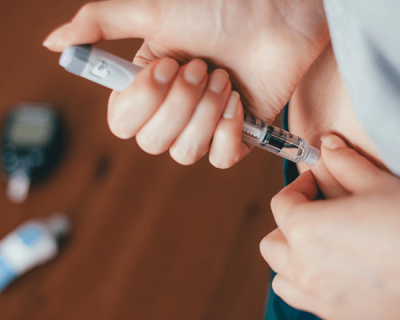 A patient self-administers insulin