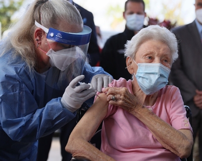Elderly woman getting a vaccine, photo credit, Joe Raedle