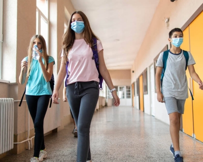 Kids walking in hallway with masks on
