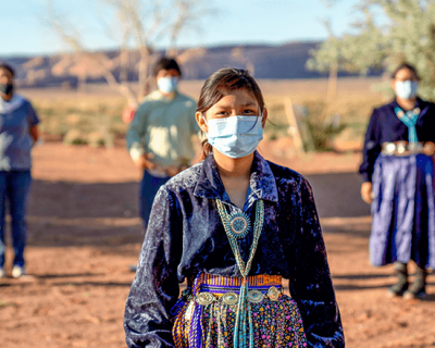 Native American woman wearing a mask