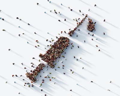 Aerial view of thousands of people forming shape of an injector
