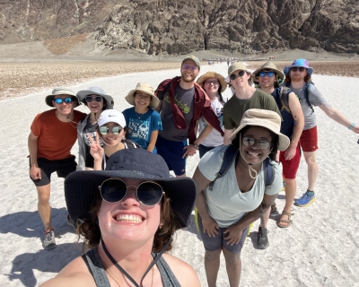 group of students in a group photo in a desert setting