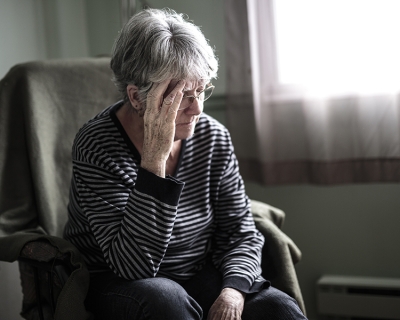 Worried senior woman at home 