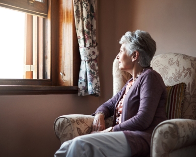 Older Woman Sitting By Window