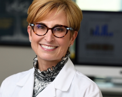 Photo of Sabra Klein in a white lab coat
