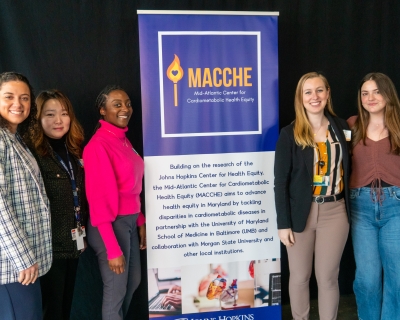 MACCHE Team Members Stand with MACCHE Sign