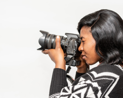 Black woman taking photos with a camera
