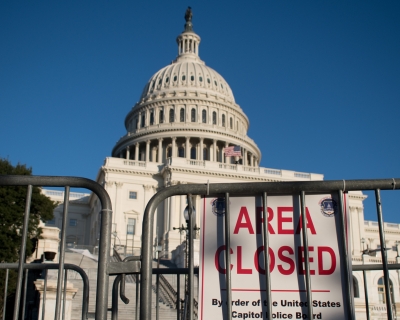Gates surrounding the United States Capital building with a sign that reads area closed