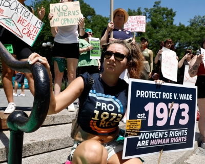 People hold up signs in Union Square during a demonstration against the Supreme Court on July 4, 2022 in New York City. The Supreme Court's June 24th decision in the Dobbs v Jackson Women's Health case overturned the landmark 50-year-old Roe v Wade case, removing a federal right to an abortion. 