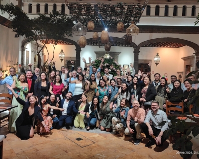 A large group of people posed for a photo in a hotel lobby