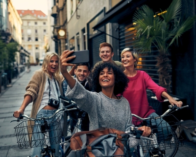 photo of young adults on bikes taking a selfie
