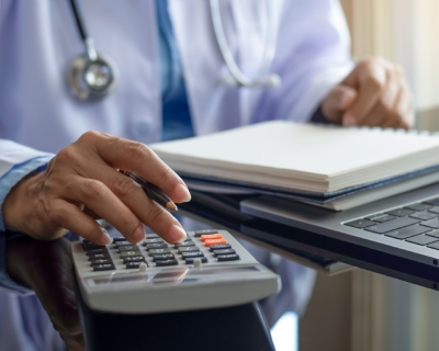 torso showing medical person using a calculator